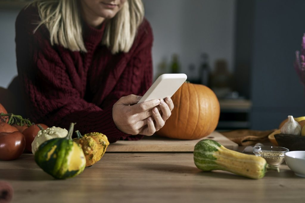 Close up of woman looking for recipe for pumpkin's soup