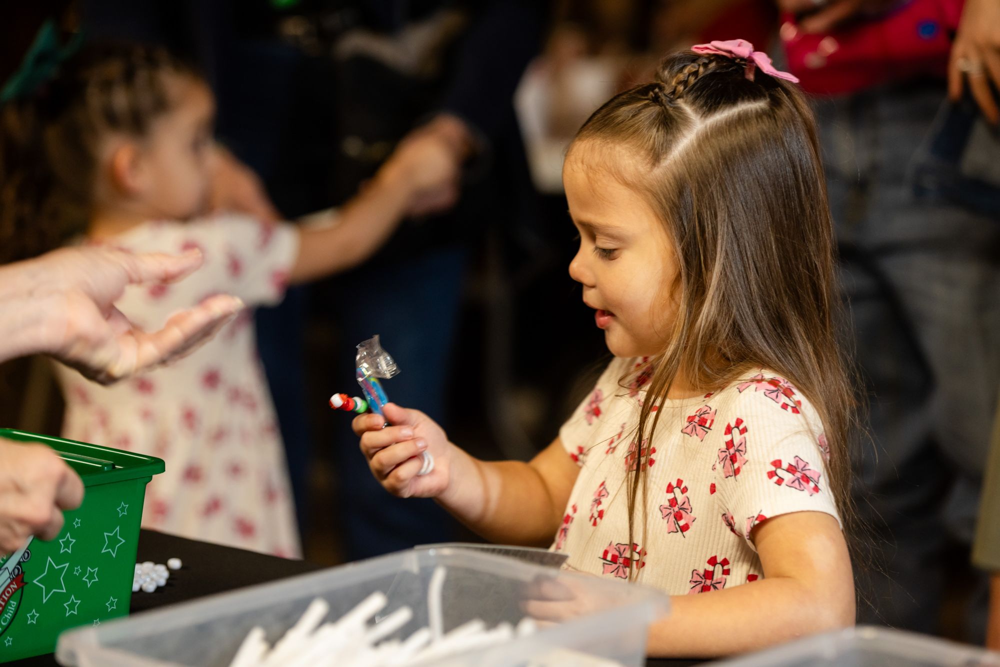 Child making a DIY Christmas ornament with Operation Christmas Child