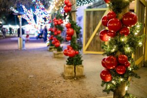 Red ornament-wrapped light posts glowing at Old West Christmas Light Fest