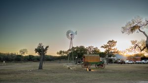 Windmill under a Texas Hill Country sky at dusk at Enchanted Springs Ranch